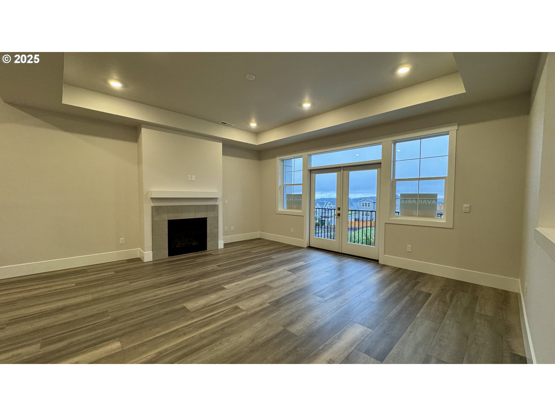11770 Southwest 176th Drive Beaverton, OR 97007 - Photo 8 of 41 a open hall with a fireplace and wooden floor