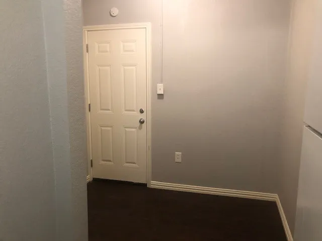 an empty room with closet area