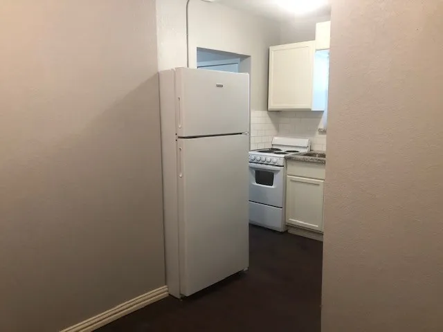 a kitchen with a refrigerator and a stove