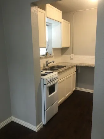 a kitchen with a stove and a sink