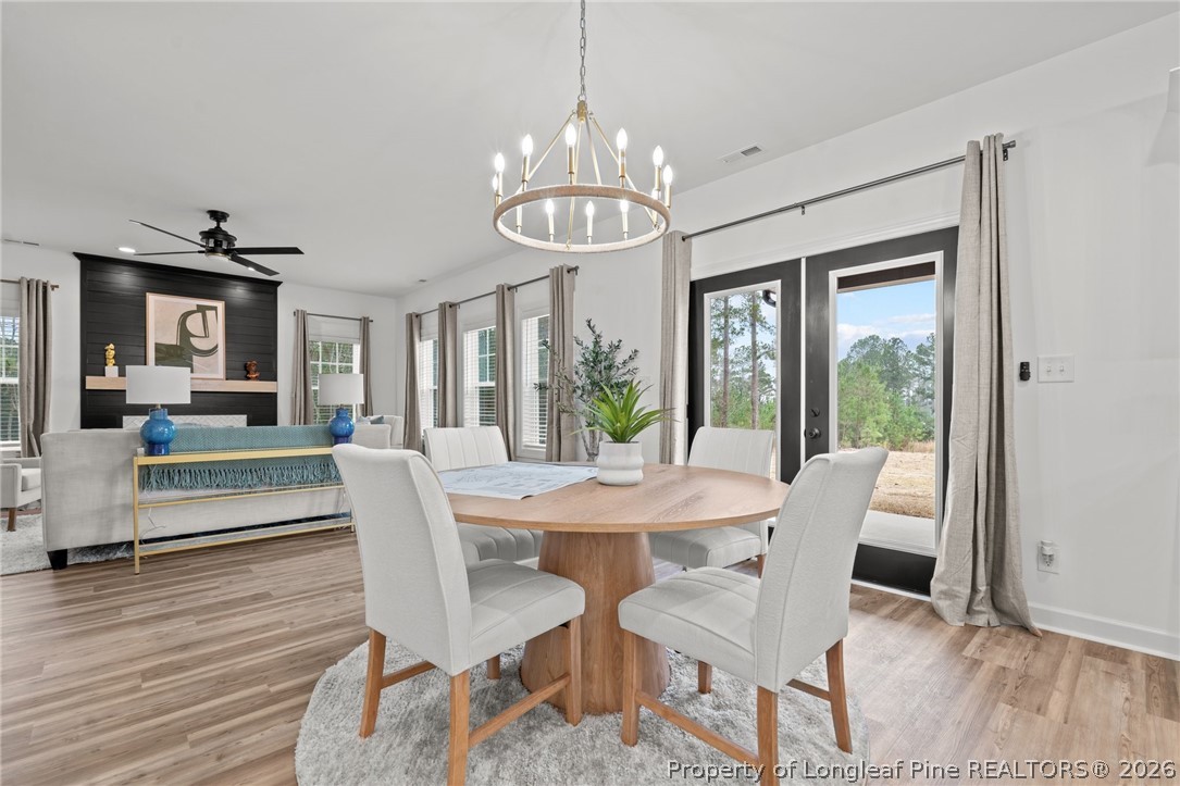 82 Magnolia Grv Way Cameron, NC 28326 - Photo 6 of 20 a view of a dining room with furniture wooden floor and chandelier