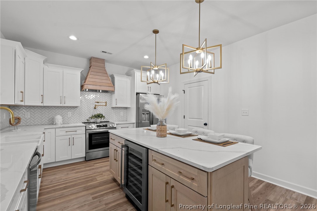 82 Magnolia Grv Way Cameron, NC 28326 - Photo 7 of 20 a kitchen that has a sink a stove and a wooden floors