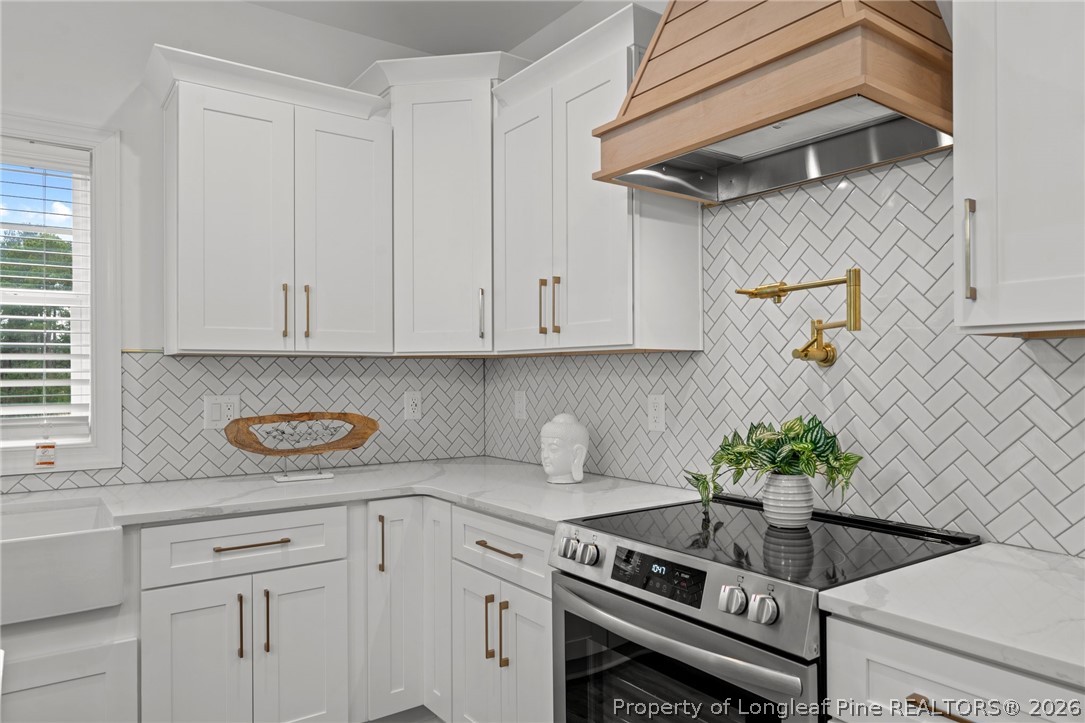 82 Magnolia Grv Way Cameron, NC 28326 - Photo 10 of 20 a kitchen with stainless steel appliances white cabinets and a stove