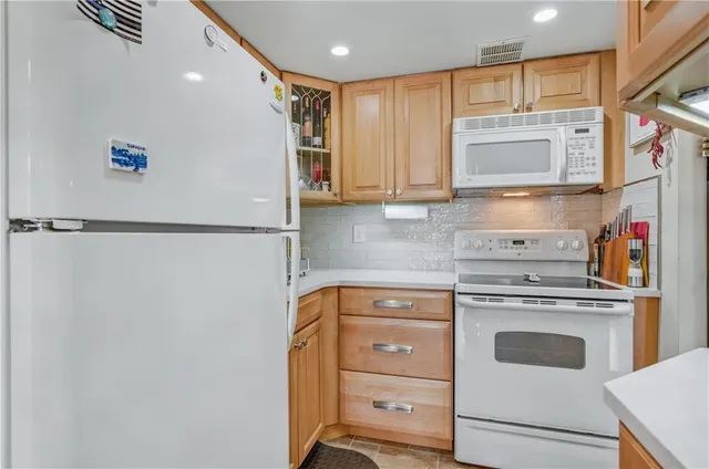 a kitchen with a refrigerator and a sink