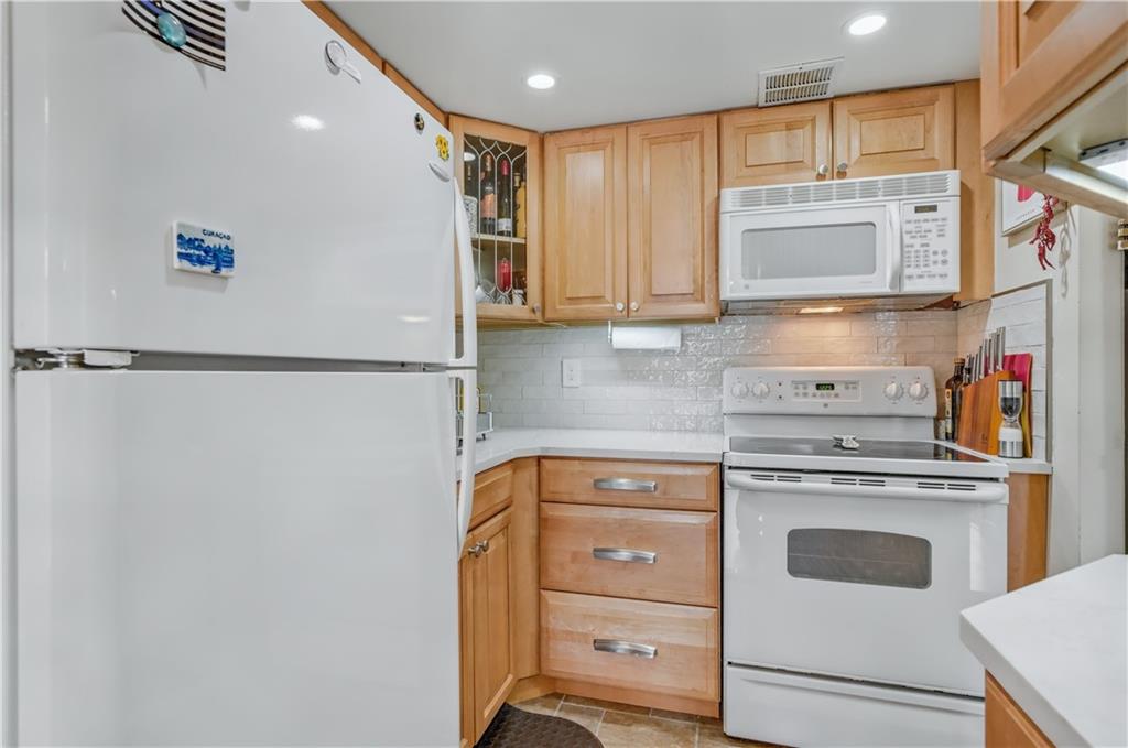 9977 Shore Road, Unit 11D Brooklyn, NY 11209 - Photo 13 of 27 a kitchen with a refrigerator and a sink