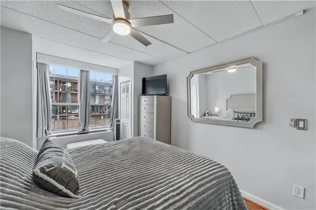 a bedroom with a large bed and a chandelier