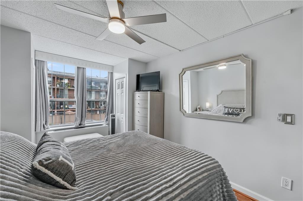 9977 Shore Road, Unit 11D Brooklyn, NY 11209 - Photo 18 of 27 a bedroom with a large bed and a chandelier