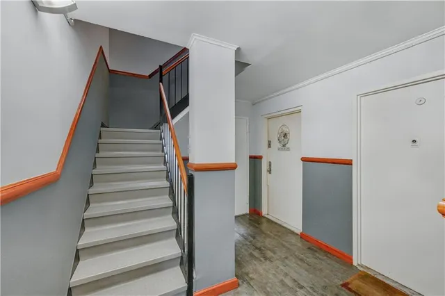a view of entryway with furniture and wooden floor