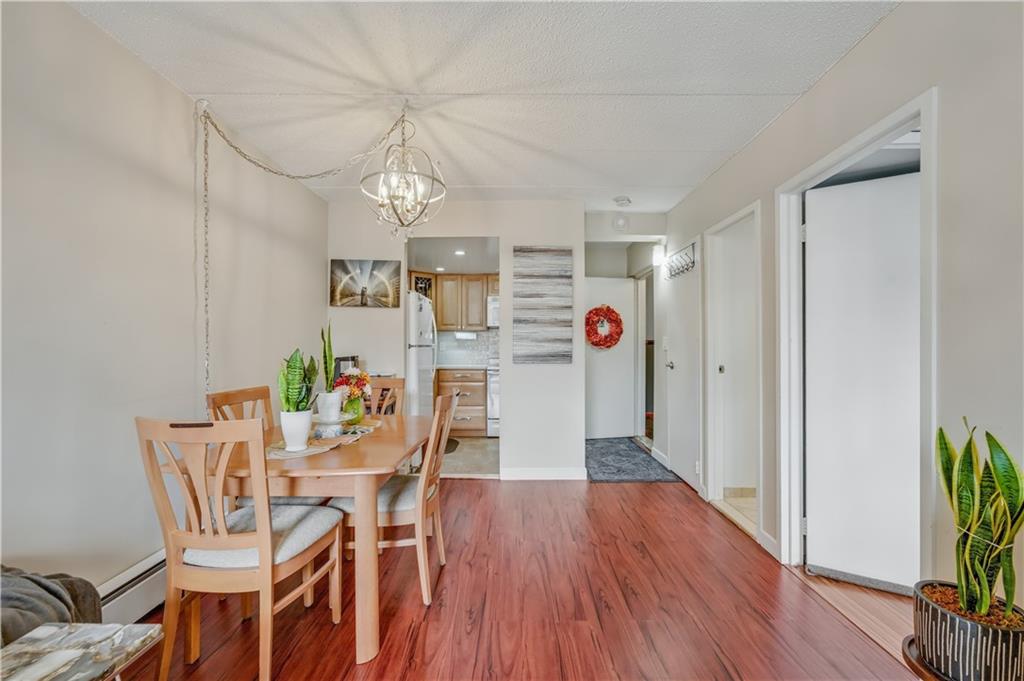 9977 Shore Road, Unit 11D Brooklyn, NY 11209 - Photo 9 of 27 a view of a dining room with furniture and wooden floor