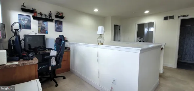 a view of workspace with wooden floor windows