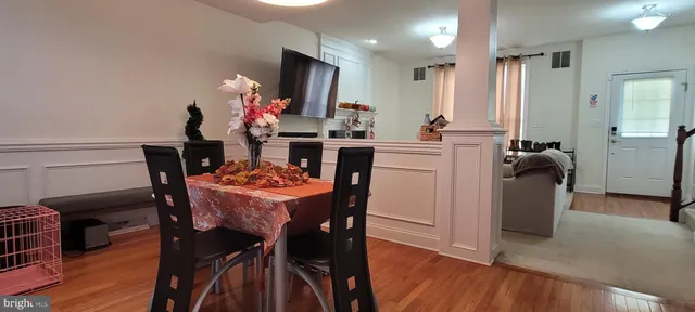 a dining room with furniture and wooden floor