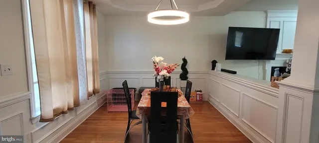 a dining room with furniture and a flat screen tv