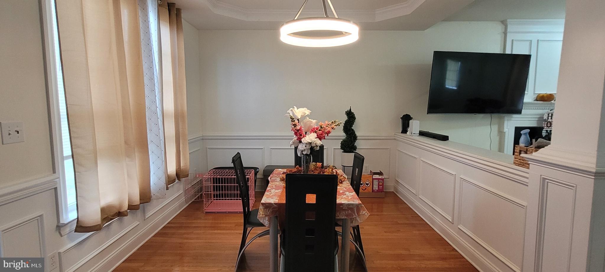 74 Redstone Court Felton, DE 19943 - Photo 10 of 33 a dining room with furniture and a flat screen tv