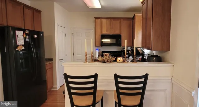 a kitchen with a refrigerator and a sink