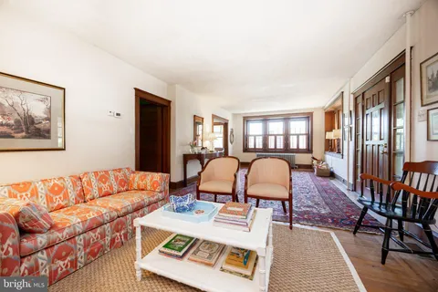 a living room with furniture a fireplace and a large window