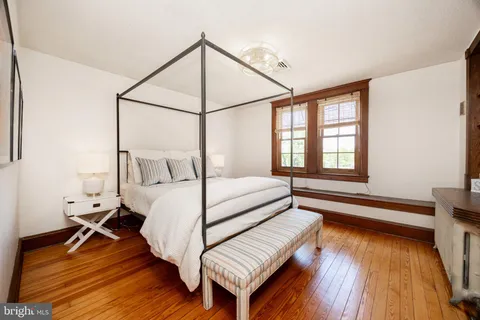 a bedroom with two beds and a chair