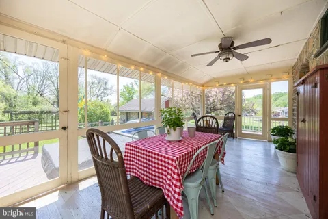 a kitchen with a sink and dishwasher with white cabinets