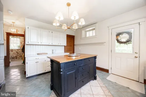 a kitchen with cabinets a sink and a refrigerator