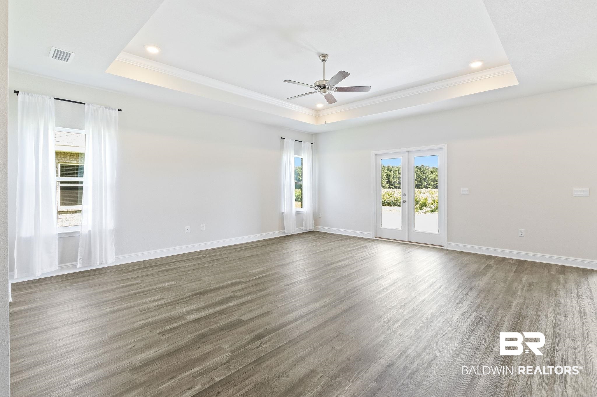 11303 Genuine Risk Circle Daphne, AL 36526 - Photo 12 of 100 Great room has a trey ceiling, crown molding and lots of natural light