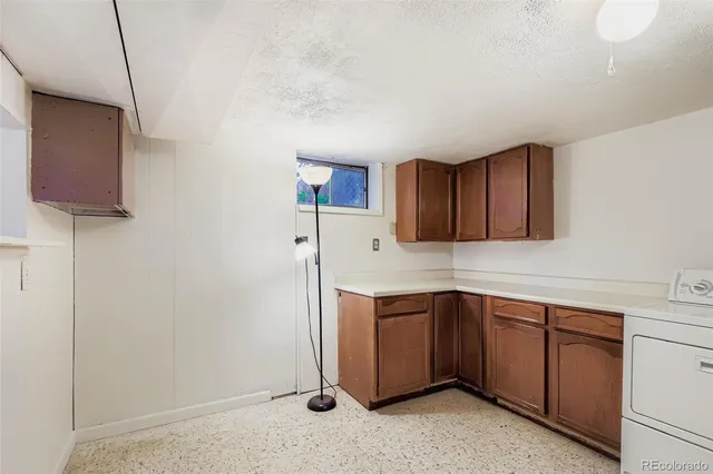 a kitchen with a sink cabinets and appliances