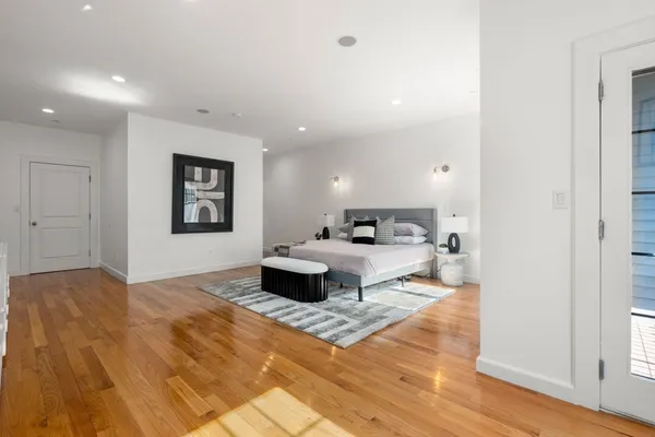 a living room with furniture and a painting on the wall