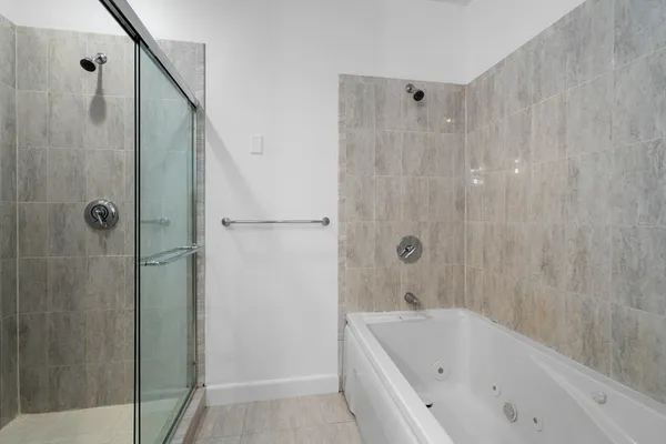 a bathroom with a bathtub and shower