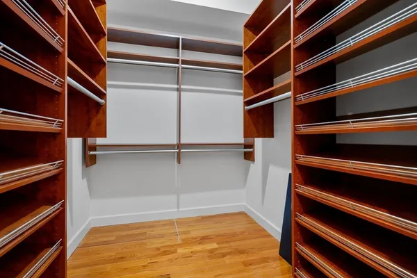 a view of walk in closet with empty racks