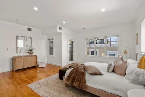 a bedroom with a large bed and a couch