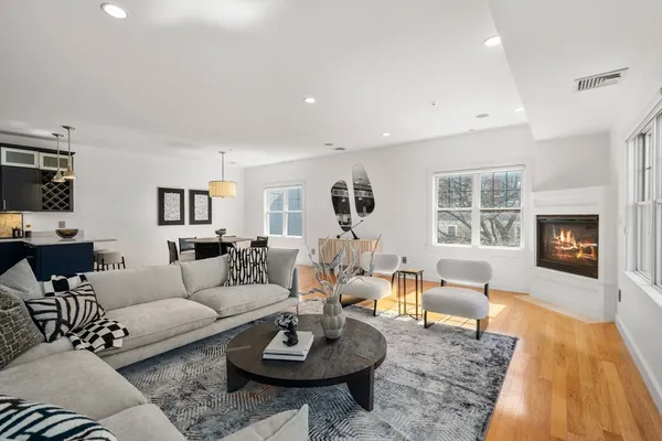 a living room with furniture wooden floor and a fireplace