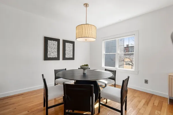 a dining room with furniture and window