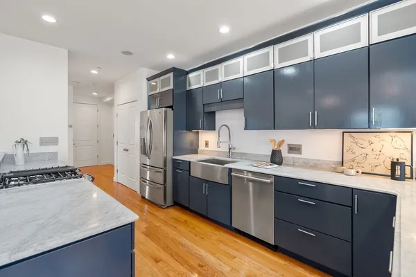 a kitchen with a sink stove and refrigerator