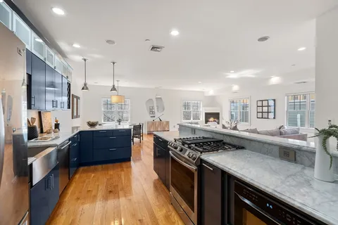 a kitchen with stainless steel appliances granite countertop a stove and a sink
