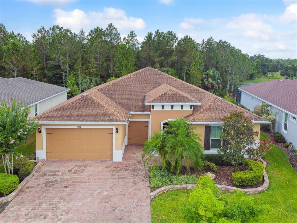 694 Irvine Ranch Road Kissimmee, FL 34759 - Photo 1 of 1 a aerial view of a house next to a yard