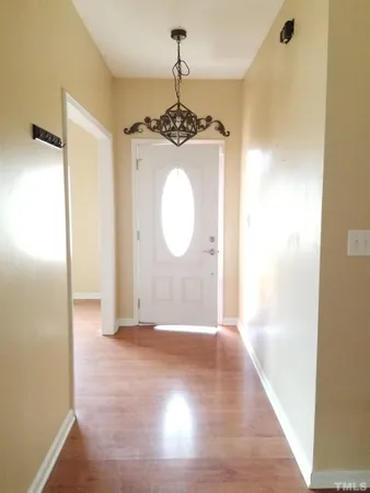a view of a hallway with wooden floor