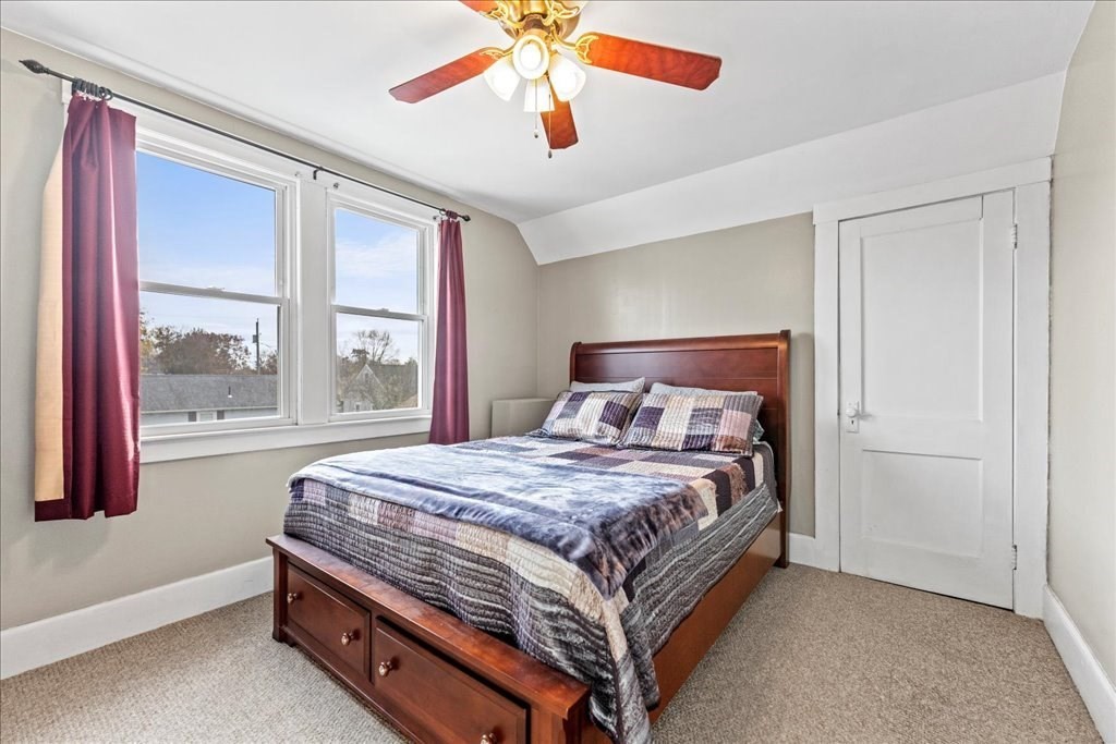11 Mary Street Springfield, MA 01118 - Photo 23 of 42 a bedroom with a large bed and a chandelier fan
