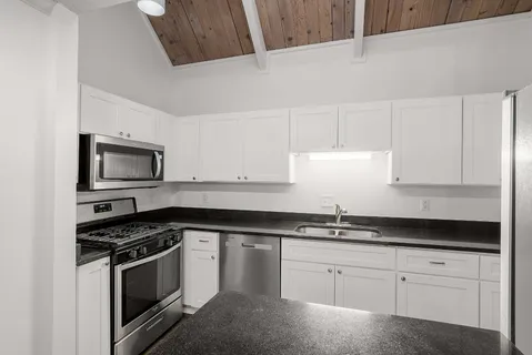 a kitchen that has a sink and a stove