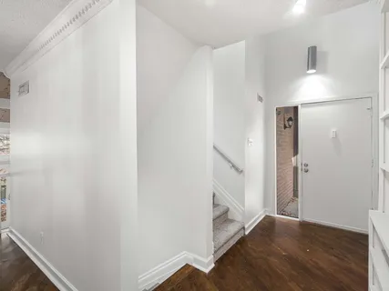 a living room with furniture a couch and a potted plant