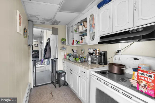 a kitchen with a stove and cabinets