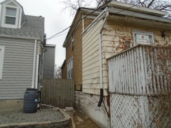 a view of a house with a wooden bench