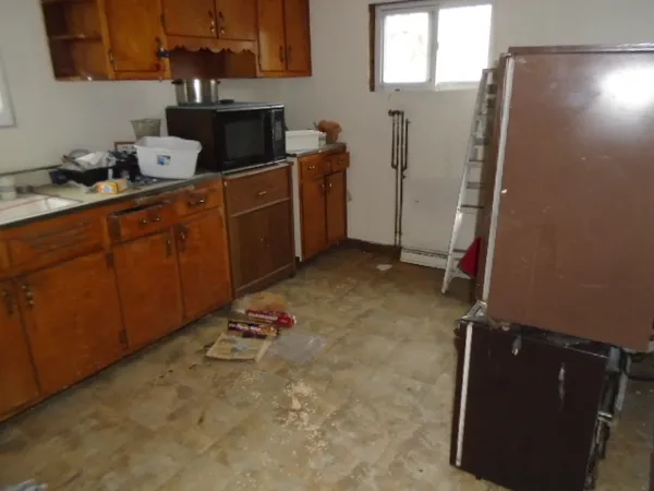 a kitchen with sink cabinets and utility room