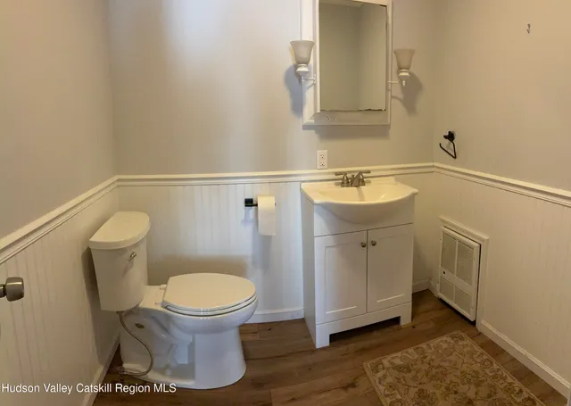 a bathroom with a sink toilet and mirror