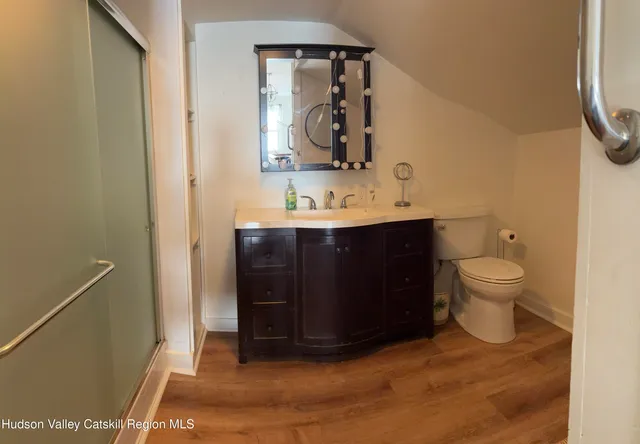 a bathroom with a toilet sink and mirror