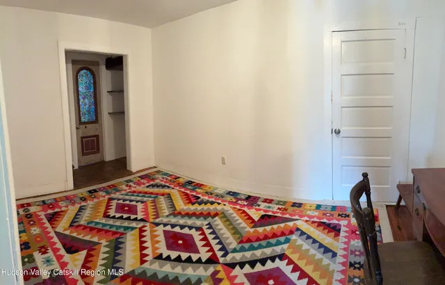 a bedroom with a bed and a book shelf