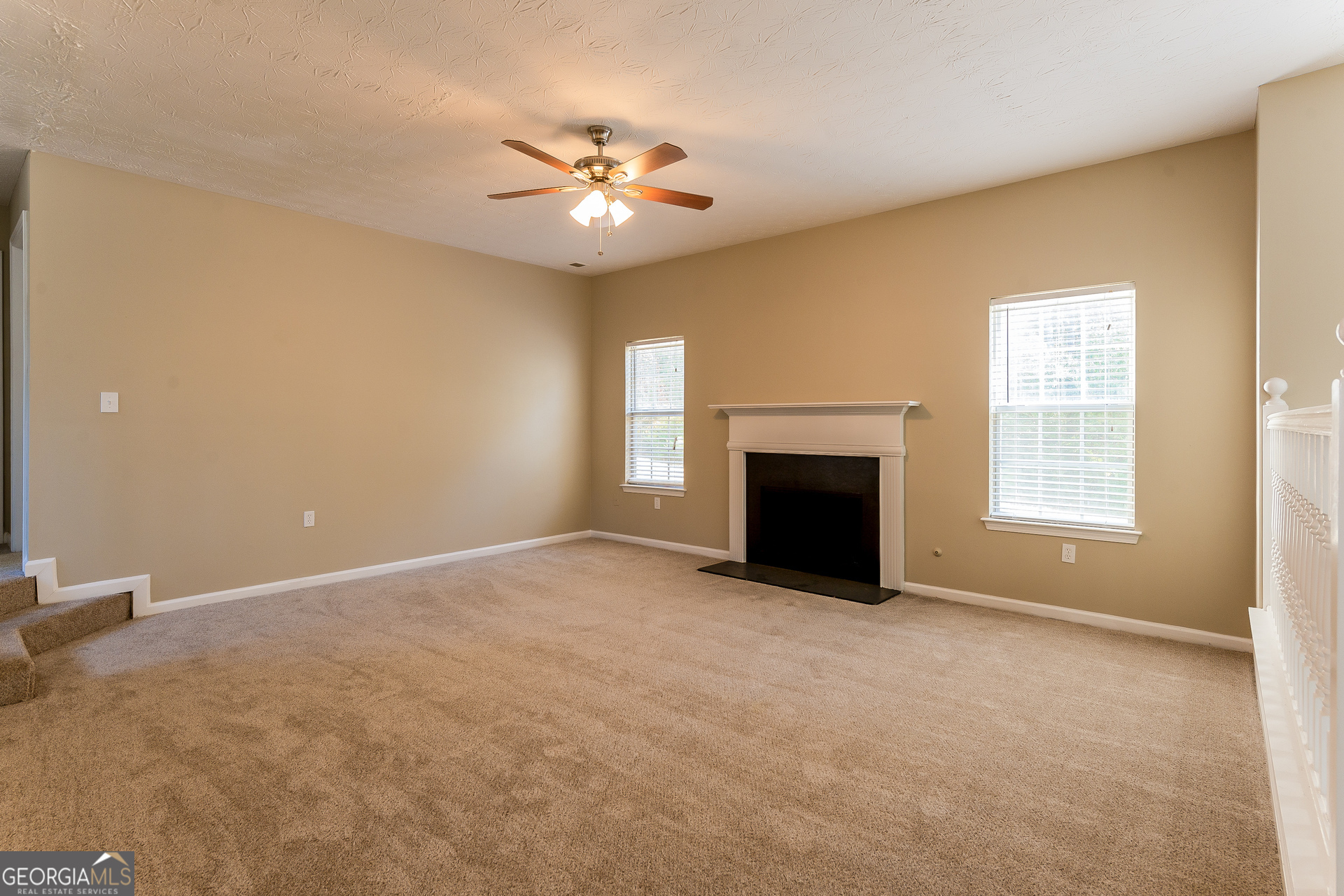 231 Biltmore Way Stockbridge, GA 30281 - Photo 3 of 15 an empty room with windows and fireplace