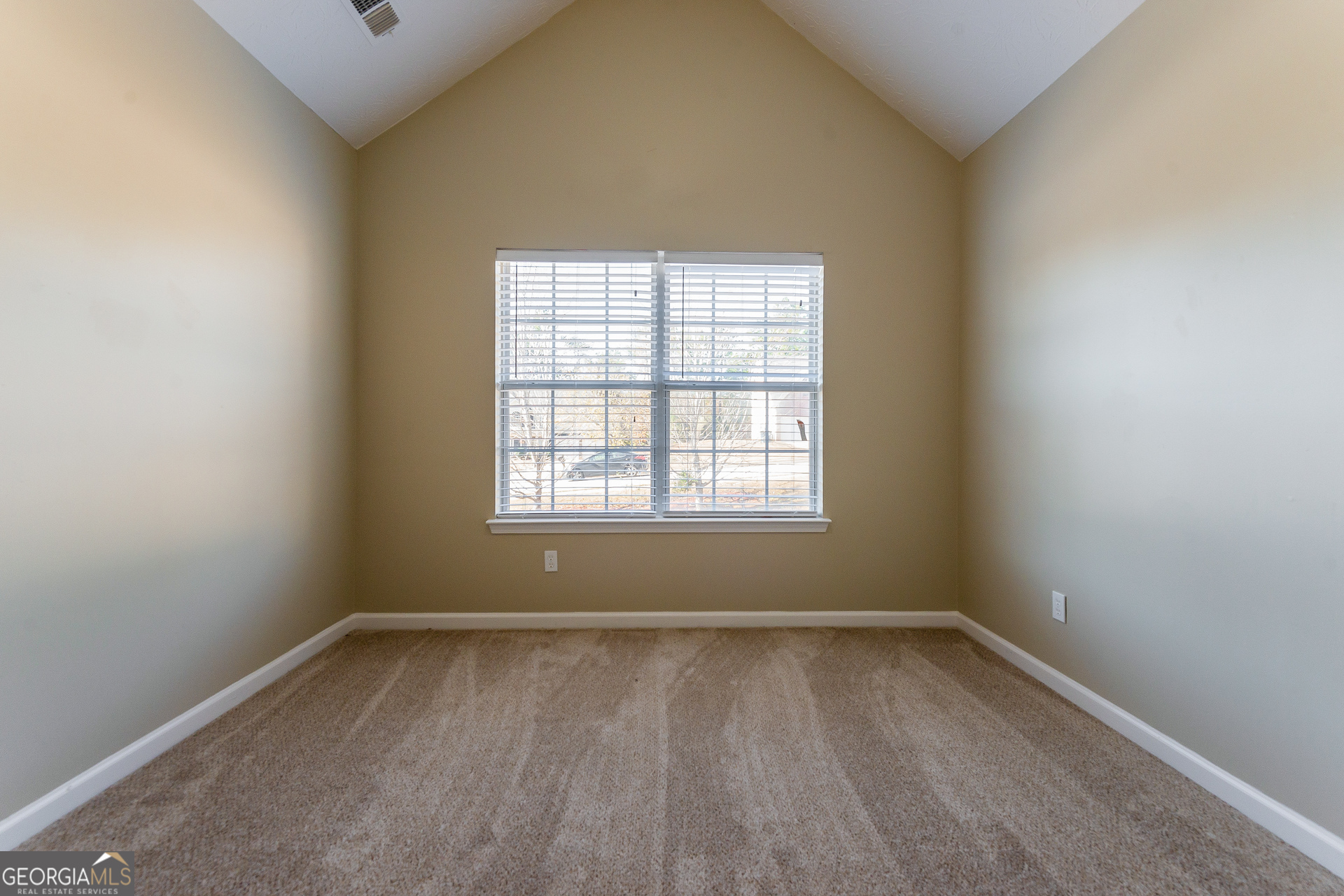231 Biltmore Way Stockbridge, GA 30281 - Photo 7 of 15 an empty room with wooden floor and windows