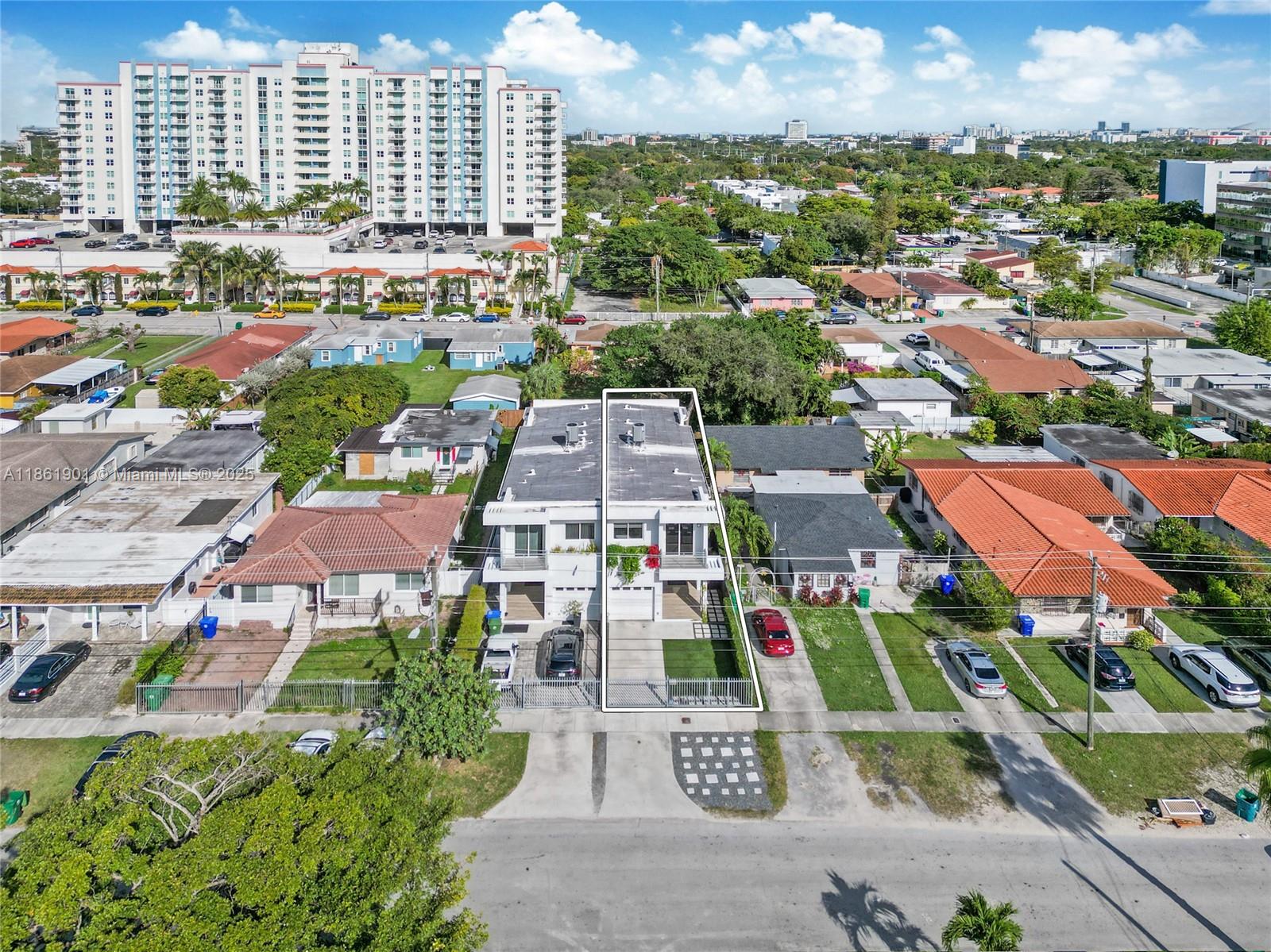 an aerial view of residential houses with outdoor space