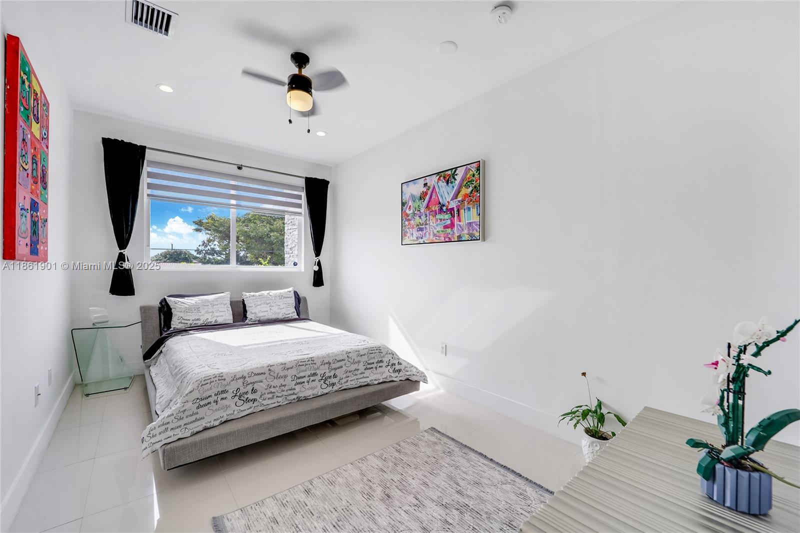 2943 Southwest 23rd Street Miami, FL 33145 - Photo 11 of 21 a bedroom with a bed a window and a potted plant