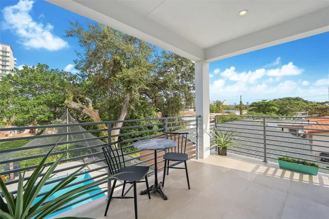 a view of a chairs and table in the balcony