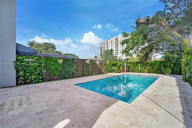 a view of a swimming pool with a yard