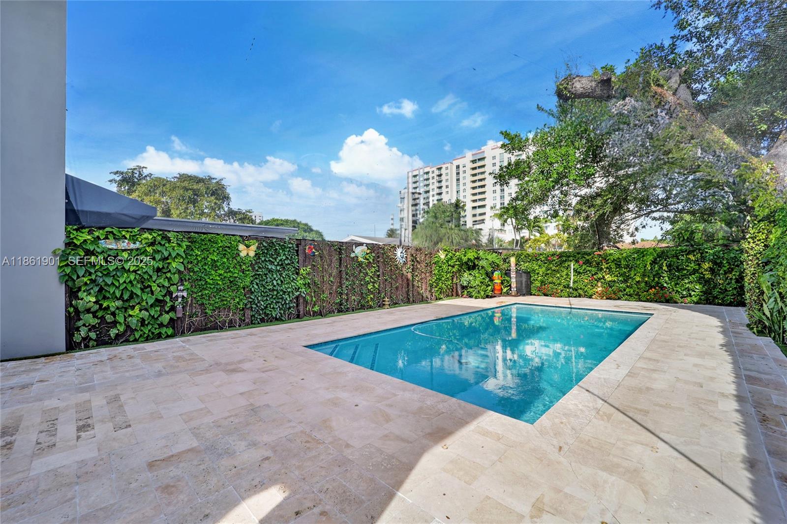 2943 Southwest 23rd Street Miami, FL 33145 - Photo 17 of 21 a view of a swimming pool with a yard